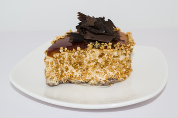 A cake with chocolate on a white plate 