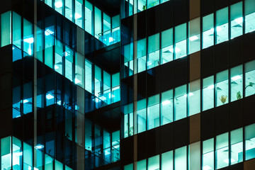 Modern office windows of skyscraper glowing at night