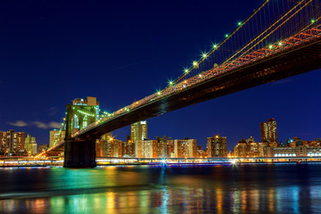 Fototapeta na wymiar Brooklyn Bridge over East River at night in New York City Manhattan