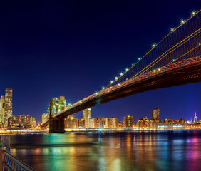 Fototapeta na wymiar New York City Manhattan Bridge over Hudson River with skyline after sunset night view illuminated l