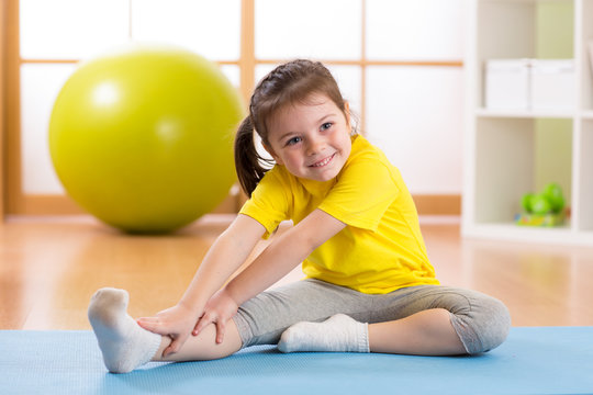Preschooler child girl doing fitness exercises