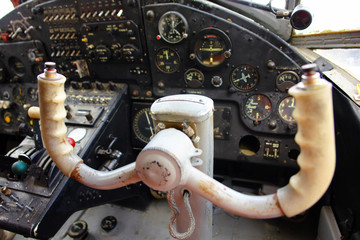 Inside the cockpit of the old plane. The steering wheel of the plane. Vintage airplane dashboard,...
