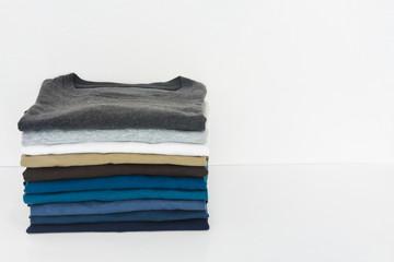 stack of t-shirt on white background, copy space