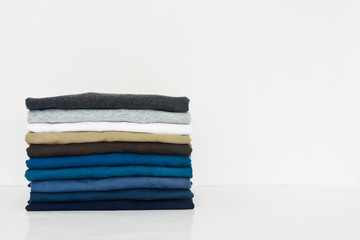 stack of t-shirt on white background, copy space