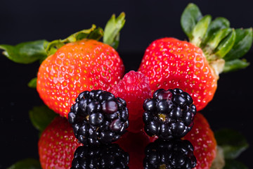 Assorted berries isolated on black