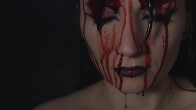 4k shoot of a horror Halloween model - Blood pouring on a Vampire face