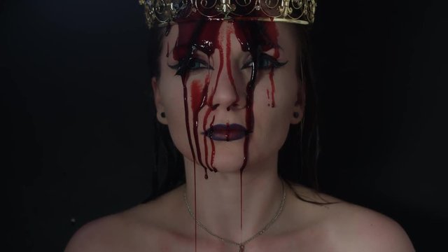 4k shoot of a horror Halloween model - Vampire with crown and blood on head