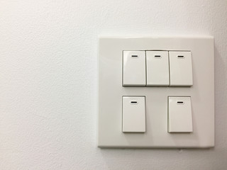 Light switches on white wall background