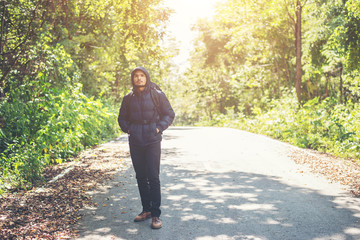 Hiker man walking on the rural road on vacation. Holiday tourism