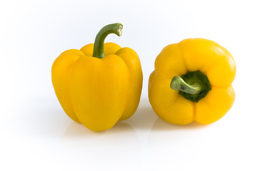 Two yellow peppers isolated on white background. Still life picture taken in studio with softbox.