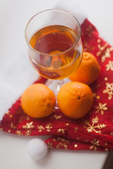 Glasses with alcoholic drinks, fresh mandarins, bokeh