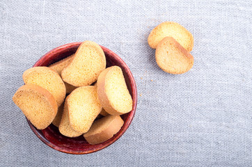 Slices of dried bread in an old wooden bowl