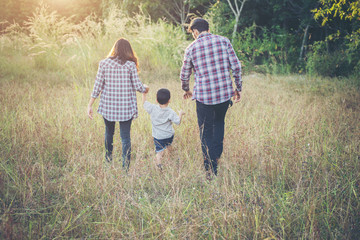 Rear of young family spending good time together. Family outdoor