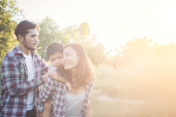 Happy young family spending time together outside in green natur