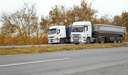 Two big trucks on road