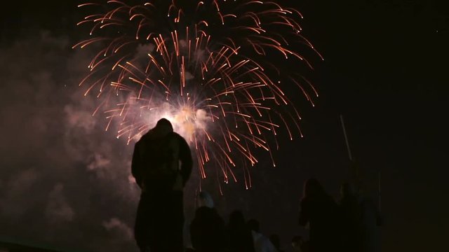 A Group Of People Watching Fireworks From The Roof Of The House On 9th May