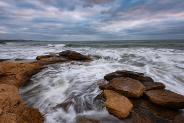 Cloudy dramatic sky, big waves, cloudscape just before the storm near the shore