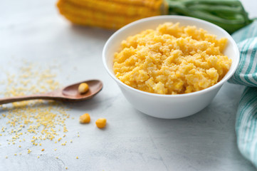 Healthy breakfast. Cooked corn porridge on concrete background. 