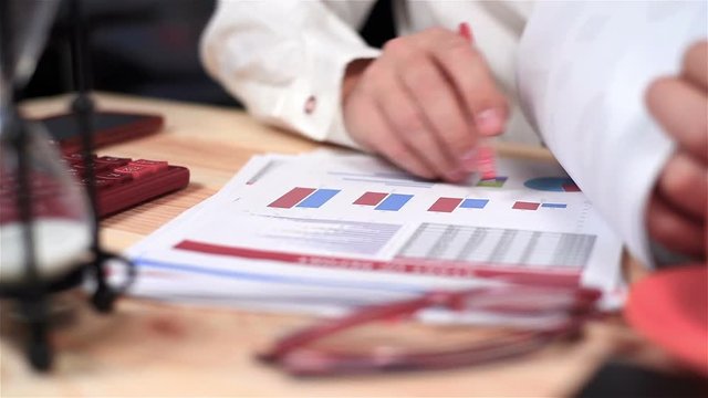 Businessman Monitoring Stock Statistics And  Financial Report. Close Up