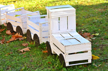 Wooden toy train in the garden of a school.