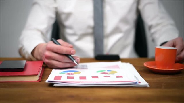 Trader Man Monitoring Stock Statistics. Close Up