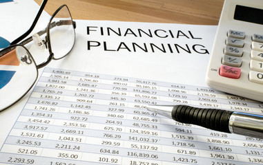 Financial planning with pen and glasses
