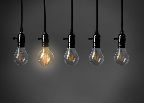 Light bulbs on gray background. Individuality concept