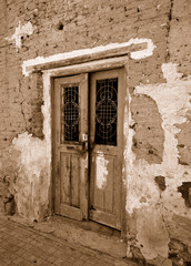 Old grungy door. Sepia