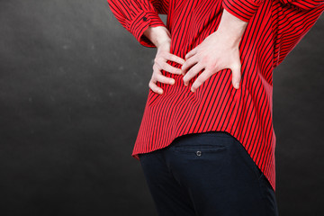 Man in red shirt having back pain