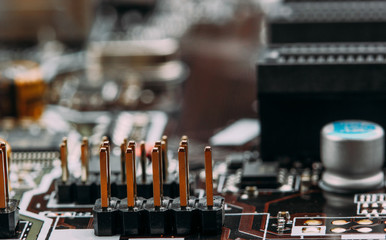 Fototapeta na wymiar transistors capacitors resistors and other electronic components mounted on motherboard(macro) closeup.selective focus