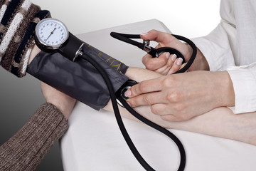 Doctor measures pressure in the patient