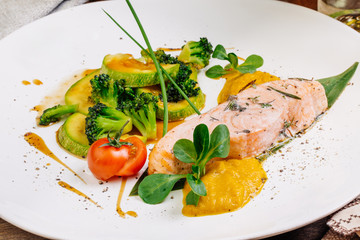 grilled salmon steak on a round white plate