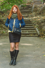 Red-haired girl with freckles looks at the camera.