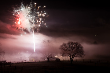 Fireworks over misty village
