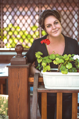 Housewife looking at the camera while in the gazebo.