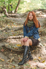 Red-haired girl with freckles looks at the camera.