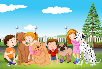 Obraz na płótnie Canvas Kids and their pet dogs in the park