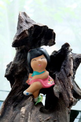 ceramic girl on a log