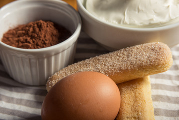 Fototapeta na wymiar Cocoa powder, mascarpone cheese, eggs and savoiardi bisccuits fo