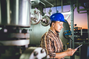 Man using tablet at Natural gas processing facility