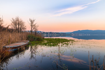 Lake Comabbio in autumn at sunset. On the background Varano Borghi; province of Varese, Italy    