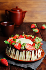 Sponge cake with cream, chocolate and strawberry