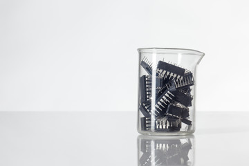 lab beaker holding many chips