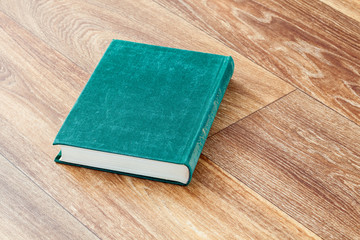 The book green colour in a firm cover.