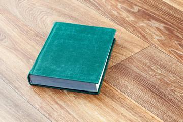 The book green colour in a firm cover.