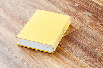 The book yellow colour in a firm cover.