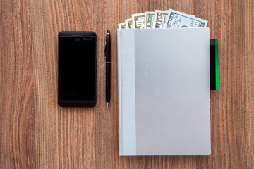 The daily log with denomination dollars on a wooden table.