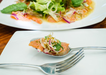 Thai spicy salmon salad on spoon