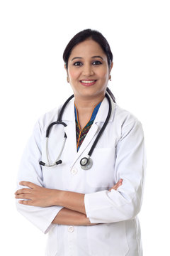 Smiling doctor woman with arms crossed against white background