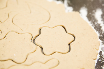 Cut the shape out of the dough for ginger cookies